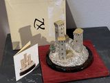 a silver statue of a castle sitting on a table