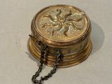 a gold box with a chain around it on a table