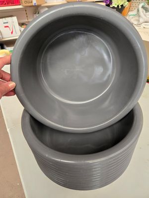 une personne tenant un bol et un bol posé sur une table