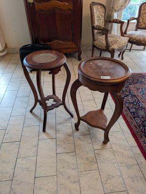 two tables that are sitting on the floor in the room
