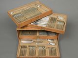two wooden boxes with silverware in them on a gray surface