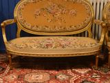 a couch and two chairs in a room with a rug