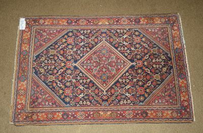an antique persian rug with a diamond design on it