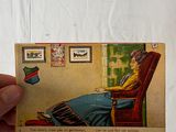 a hand holding a card with a picture of a woman sitting in a chair