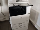 a white printer sitting on top of a white cabinet