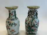 two vases sitting next to each other on a table