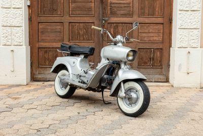 a scooter that is parked in front of a wooden door