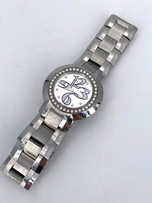 an image of a close up of a wrist watch on a white surface