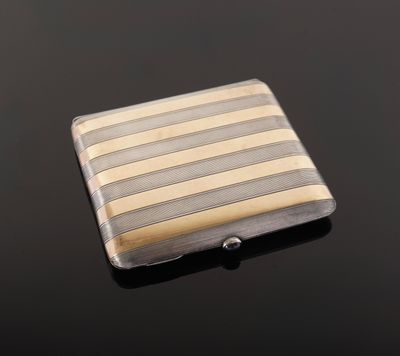 a close up of a silver and gold striped business card case