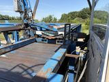 a blue truck with a crane on the back of it