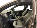 the interior of a car with the door open and the driver ' s seat down