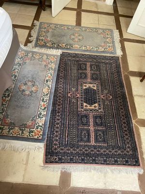 two rugs that are on the floor in the room