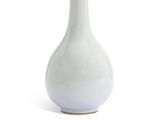 a white vase that is sitting on a white surface