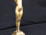 bronze statue of a woman holding a ball on a marble base