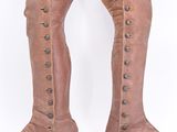 pair of brown leather boots with buttons and buckles on them