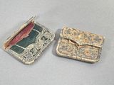 two pieces of jewelry that are sitting on a table