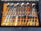a lot of spoons and forks in a case