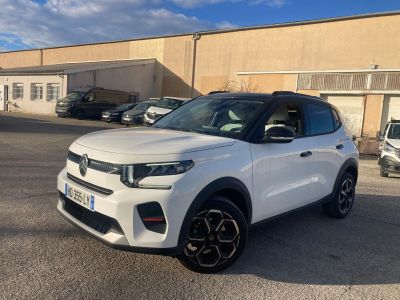 a white suv parked in a parking lot next to a building