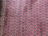 an image of a red rug with a pattern on it