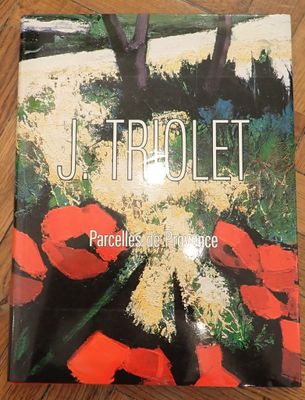 a book on a wooden table with red flowers on it