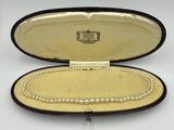 an image of a case with pearls in it on a white surface
