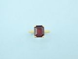 an image of a ring with a red stone in it