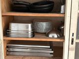 many pans and pans on the shelves in the kitchen