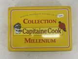 yellow tin box of captain cook millenium with a red bird on top