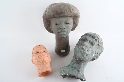 three clay sculptures of a woman and a fish