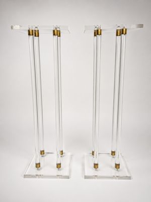 a pair of clear acrylic and brass plated candles