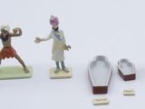five figurines of people in different poses