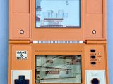 an orange game console with a game on the screen