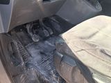 the interior of a car with the door open and the driver ' s seat down