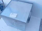 a metal box with a sticker on it sitting on the floor