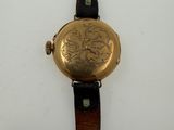 a close up of a watch on a white surface with a white background
