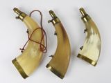 three horn horns with brass fittings on them on a white surface
