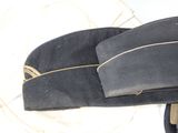 a black hat that is on top of a white plate