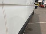 a white van that is parked in a parking lot