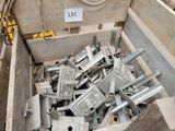 a wooden box filled with assorted pieces of metal