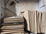 a box full of old letters and papers on the floor