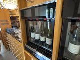bottles of wine are lined up on a shelf in a wine cellar