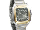 the watch is silver and gold with roman numerals on the dial