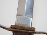 a knife that is on top of a piece of metal