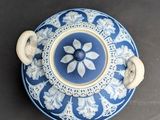 a blue and white vase with a flower design on it
