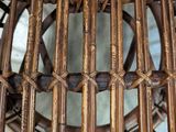 a close up of a rattan chair with a mirror in it