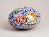 a multicolored ball sitting on a white surface