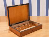 a wooden box that has a drawer inside of it