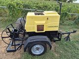 an image of a yellow machine is parked in the grass