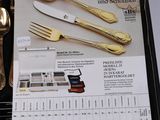 silverware in a black case on a table with a menu