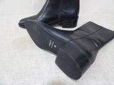 pair of women ' s black leather ankle boots on a white surface